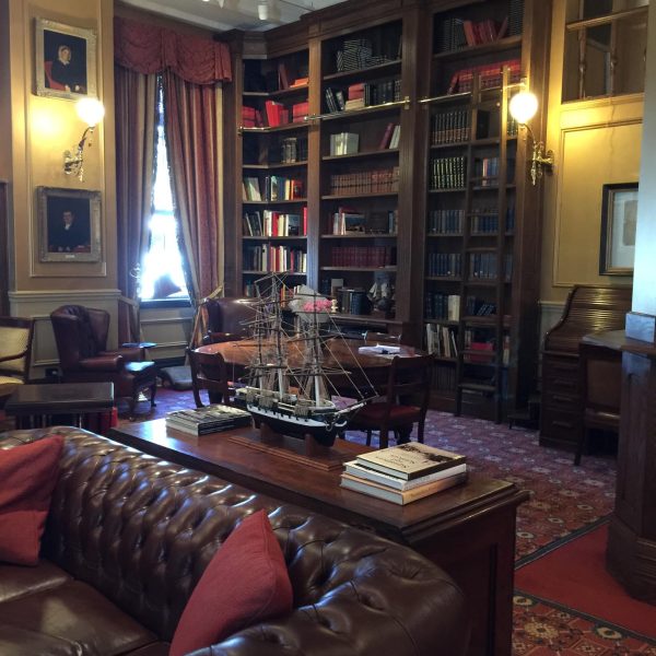 Tall Oak bookshelves with brass rail and ladder